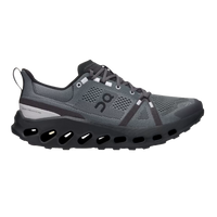 A trail running shoe with a flexible, soft-mesh upper and a shock-absorbing sole, predominantly in black color with gray elements.