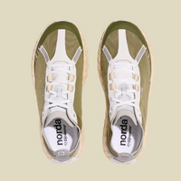 Pair of green and white sneakers with 'norda' branding on a beige background