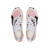 Pair of white sneakers with pink accents on a beige background