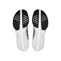 Pair of white shoe insoles with black soles on a beige background