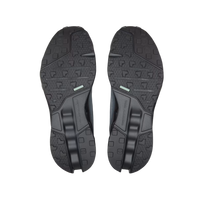 Black shoe soles on a beige background