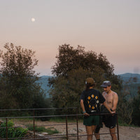 Two people standing side by side with a black background