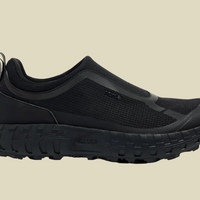 A black, laceless, supportive approach shoe with a customized Vibram midsole and soleplate, featuring a Bio-Dyneema upper and a padded heel collar.