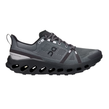 A trail running shoe with a flexible, soft-mesh upper and a shock-absorbing sole, predominantly in black color with gray elements.