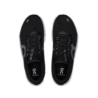 Black running shoes with 'On' branding on a beige background