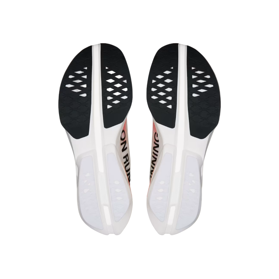 Pair of white shoe insoles with black soles on a beige background