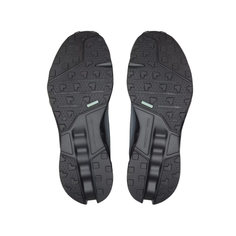Black shoe soles on a beige background